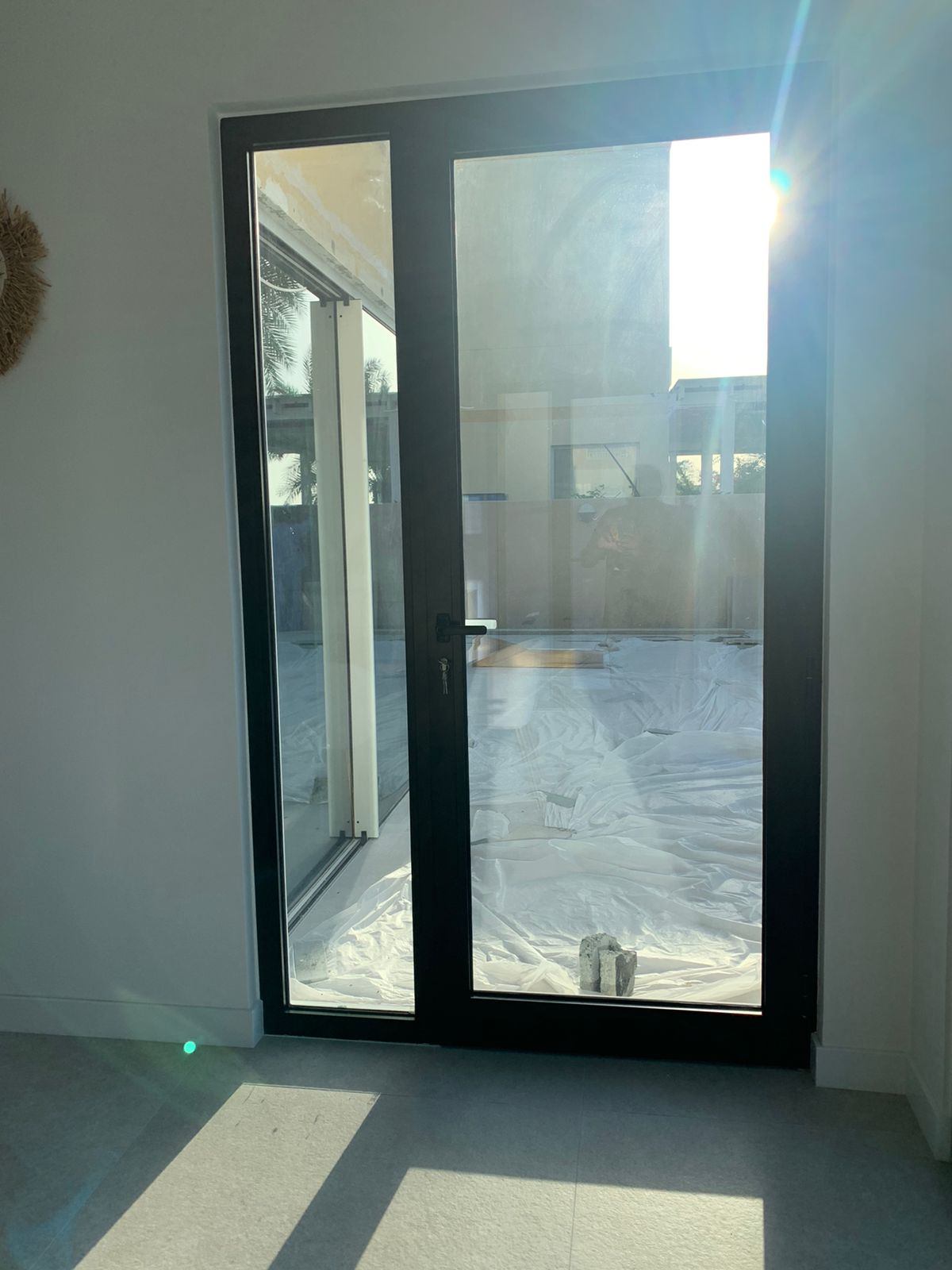 Pivot Doors 5 Black framed full-height glazed double door opening to a garden - Zealcon