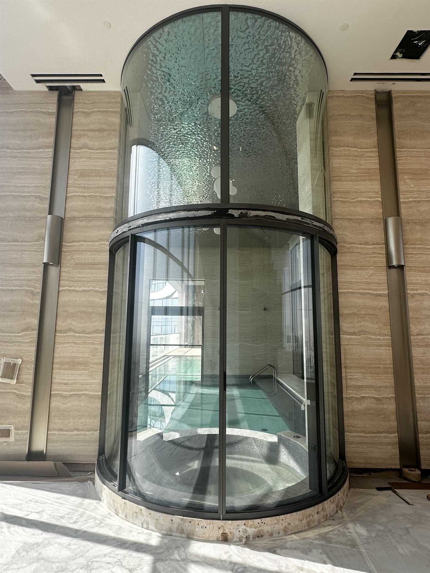Home 14 Curved glass enclosure with dark frame over a pool area - Zealcon