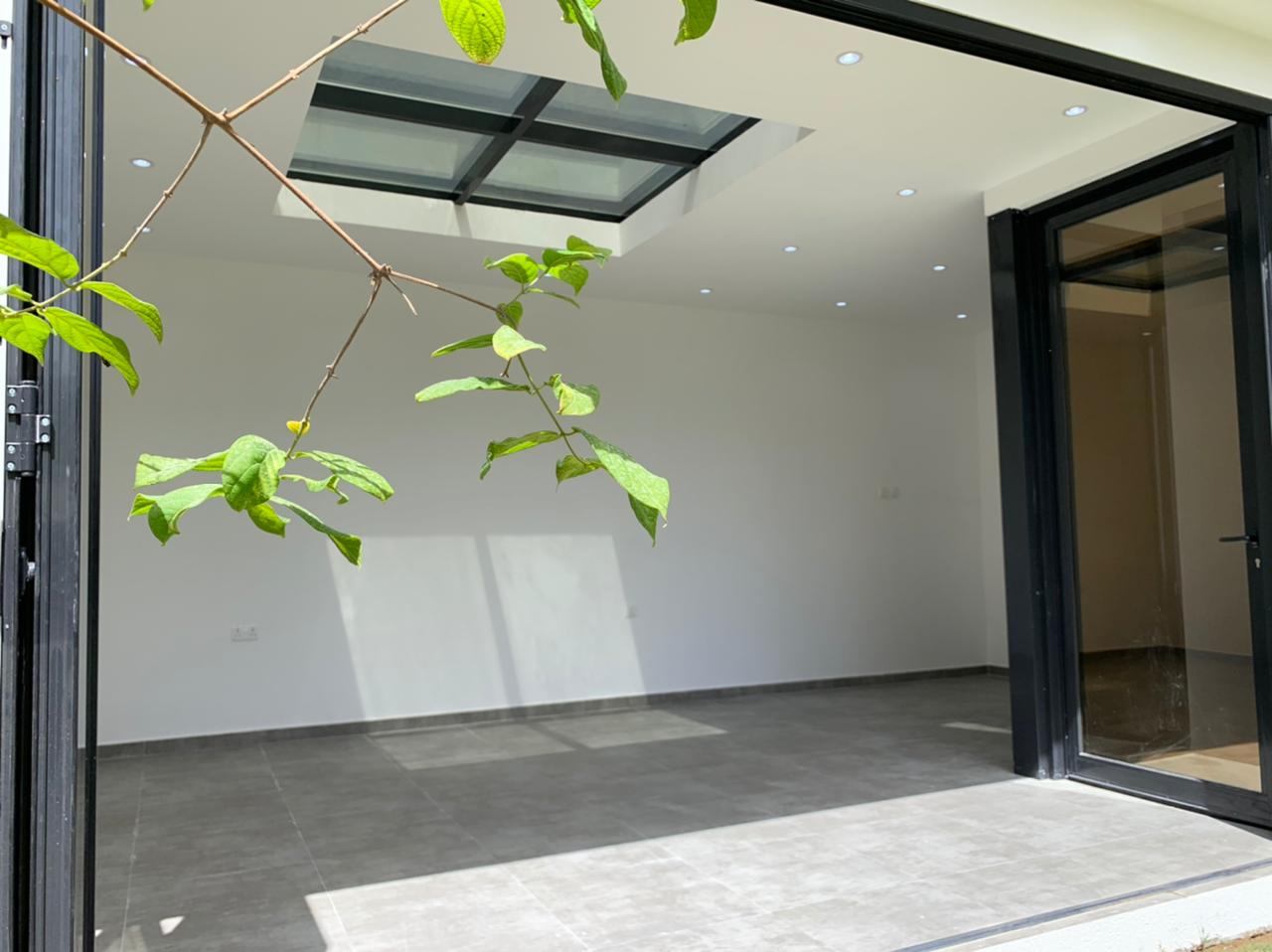 Bi-Folding Doors 5 Black corner bi-folding door system opening a room to the garden - Zealcon