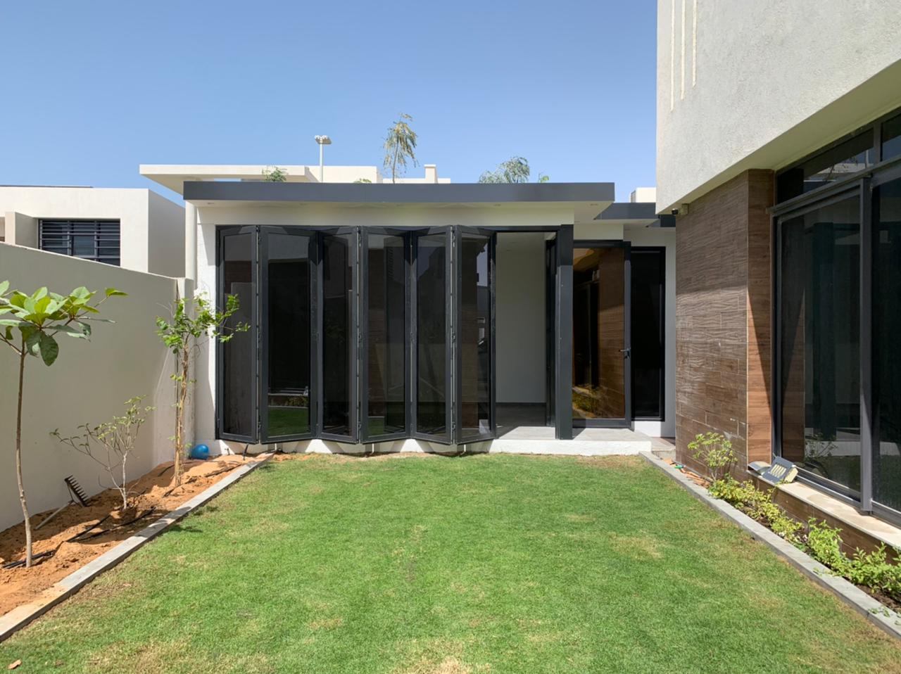 Structural Glazing & Glass Facades 2 Glazed courtyard entrance with black frames and timber cladding - Zealcon