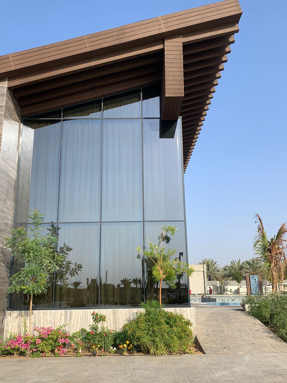 Structural Glazing & Glass Facades 6 Reflective glass facade corner with a wooden roof edge - Zealcon
