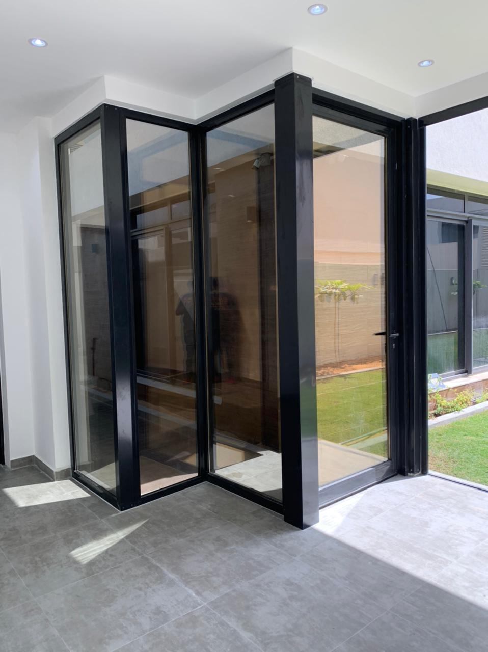 Pivot Doors 6 Black framed corner glazing with pivot door - Zealcon