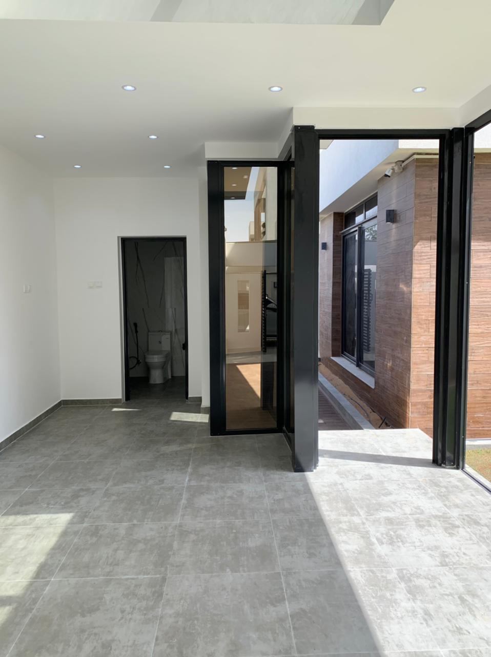 Pivot Doors 2 Black framed glazed entrance to a patio - Zealcon