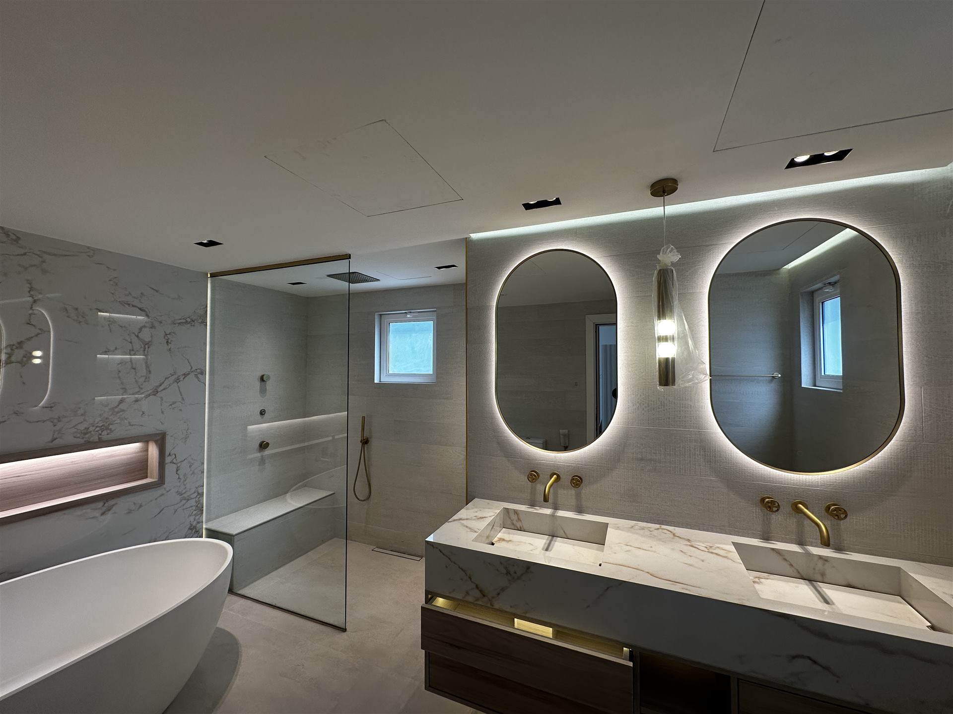 Shower Glass 4 Clear glass walk-in shower beside a double vanity and freestanding bath - Zealcon