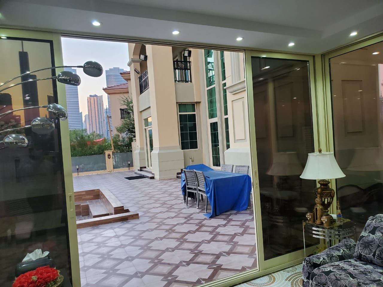Gold framed sliding glass doors opening to a villa terrace - Zealcon