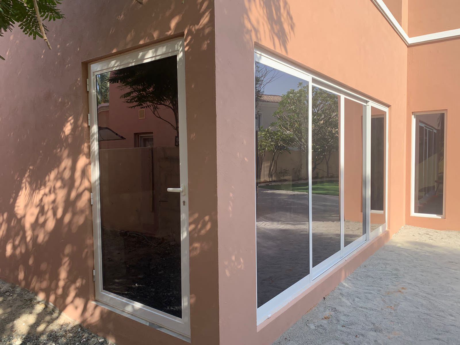 Slim Sliding Doors 4 White corner sliding glass doors on a villa exterior - Zealcon