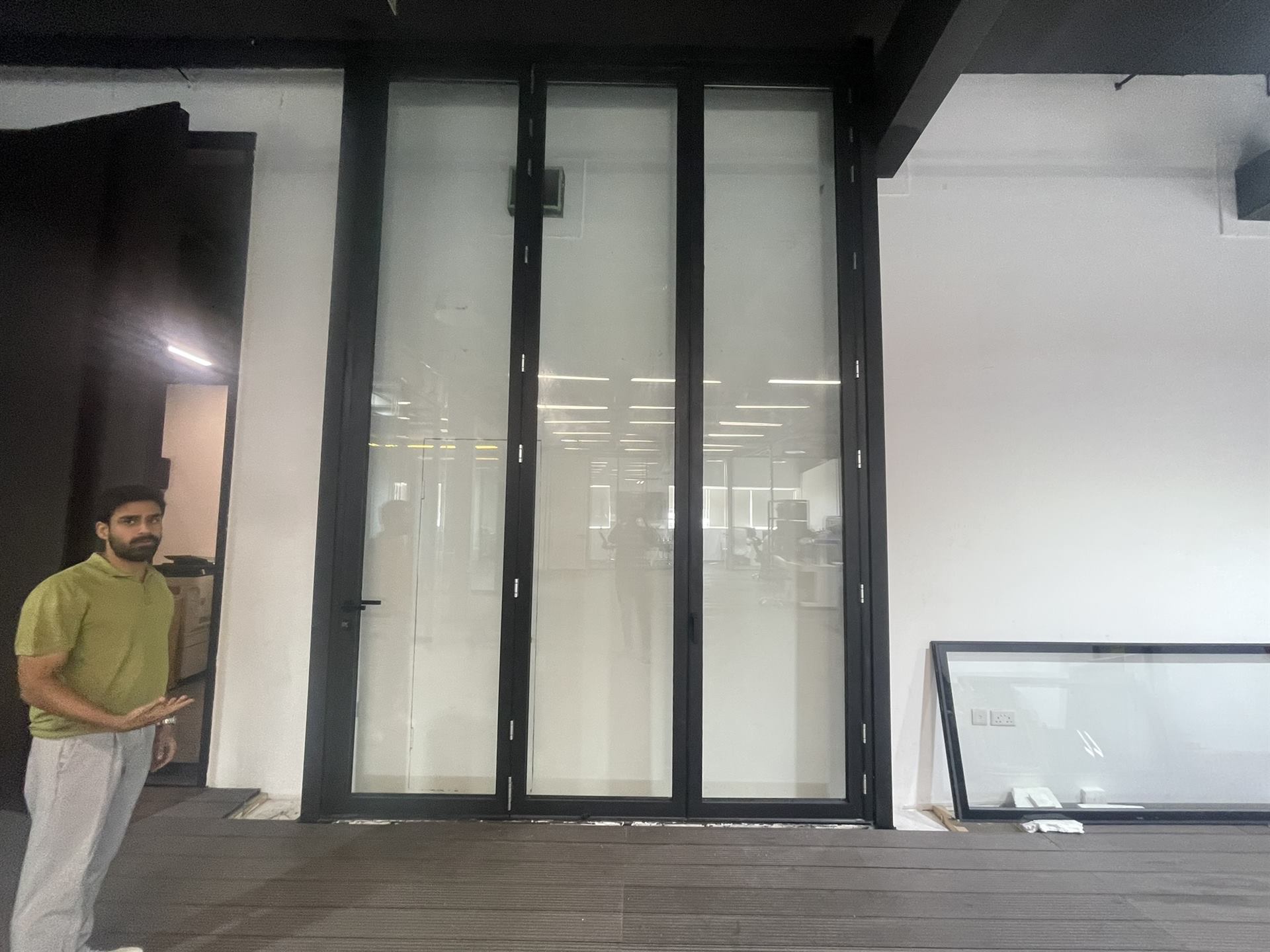 Facade Maintenance 4 Zealcon team member beside an installed folding glass door - Zealcon