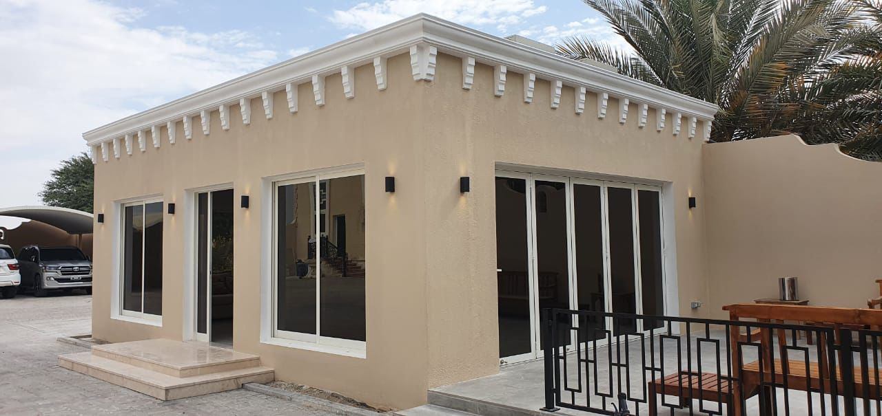 Villa annex with white framed sliding windows and decorative cornice - Zealcon