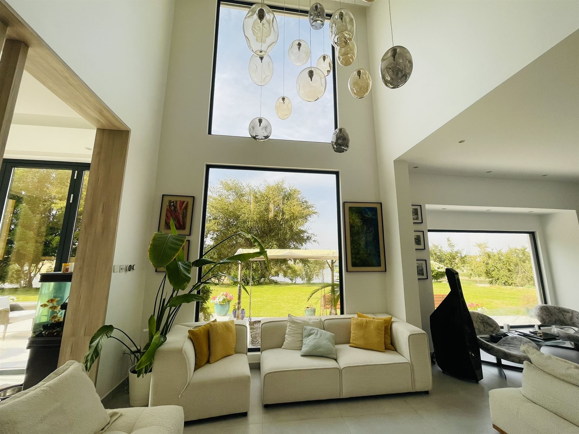 Custom Mirrors 4 Double height living room with large black framed windows - Zealcon